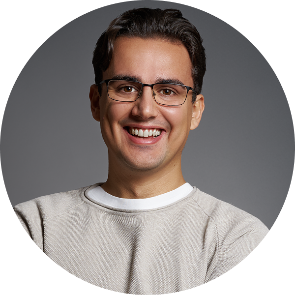 Linxact founder and CEO Daniel Lux smiling in front of a grey background